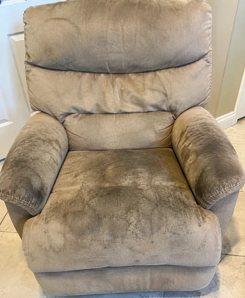 Fabric recliner before cleaning — worn and stained